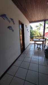a room with a table and dolphins on the wall at Pousada Ponta da Baleia in Barra Grande +37 photos