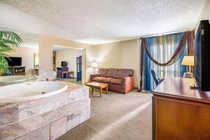 a living room with a large tub and a couch at Riverside Hotel in Casper
