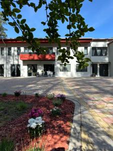 an office building with a courtyard with flowers at visitDINAMO in Kandava