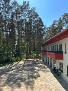 anterior view of a building with trees in the background at visitDINAMO in Kandava