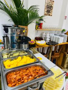 a buffet with many different types of food in trays at Pousada Ponta da Baleia in Barra Grande