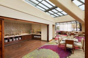 a dining room with a skylight and a table and chairs at Walnut Creek Marriott in Walnut Creek