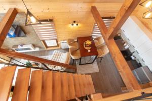 an overhead view of a living room with a table and chairs at Tara Vista Cabin in Zaovine