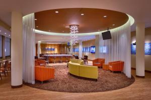 a lobby with chairs and a table and a chandelier at SpringHill Suites Coeur d'Alene in Coeur d'Alene