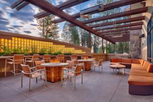a patio with tables and chairs and a bar at SpringHill Suites Coeur d'Alene in Coeur d'Alene