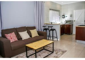 a living room with a couch and a table at Thito Manor Apartment in Maun