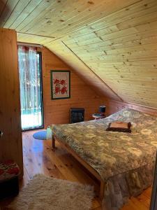 ein Schlafzimmer mit einem großen Bett in einer Holzhütte in der Unterkunft Pod Magnolią in Targanice