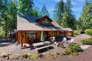 a house with a picnic table in front of it at Fireside Escape at Lake Cushman in Hoodsport