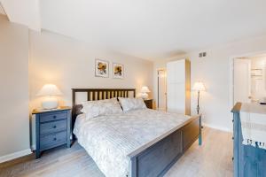 a bedroom with a bed with two night stands and two lamps at Sea Colony - 708 Brandywine House in Bethany Beach +42 photos