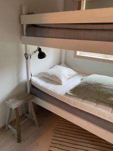 a bedroom with two bunk beds and a lamp at Villa Tjurpannan Grebbestad in Grebbestad