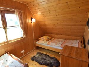 a small room with a bed in a wooden cabin at Holiday home in Kopalino in Kopalino