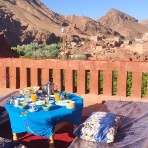 a blue table with food on top of a mountain at Gorges View Dades in Tamellalt