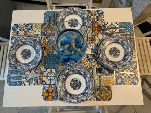 a table with blue and white plates on a table at CASA GUGHI in Rapallo +18 photos