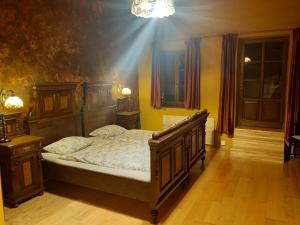 a bedroom with a bed with a wooden frame at Residence Spillenberg Classic Room in Levoča