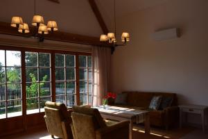 a living room with a table and a couch at Nadbużański Świt Granne in Perlejewo +6 photos
