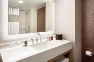 a bathroom with a sink and a mirror at Cincinnati Marriott at RiverCenter in Covington