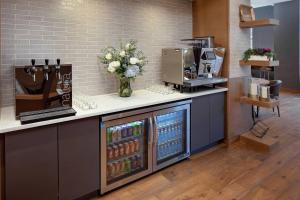 a kitchen with a counter with a drink cooler at Cincinnati Marriott at RiverCenter in Covington