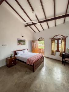 a large bedroom with a bed and a desk at Light House View Inn - Galle Fort in Galle