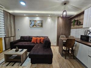 a living room with a couch and a table at LUX Apartman AS - Montevia in Zlatibor