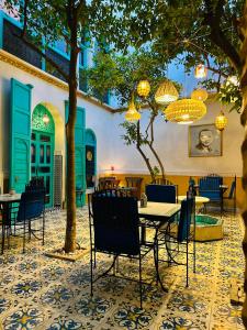 a patio with tables and chairs in a restaurant at Riad Al Nour in Marrakesh