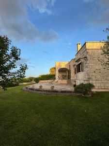 an old stone building with a grass yard at Villa Il Mio Paradiso in Fasano