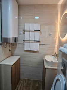 a small bathroom with a sink and a toilet at LUX Apartman AS - Montevia in Zlatibor +18 photos