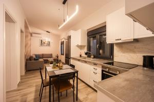 a kitchen and dining room with a table and chairs at MonteCasa in Epanomi