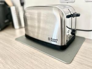 a toaster sitting on top of a counter at Maidstone City Centre Penthouse Apartment in Kent