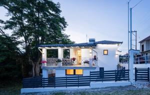 a small white house with a balcony at MonteCasa in Epanomi