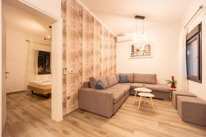 a living room with a couch and a table at MonteCasa in Epanomi