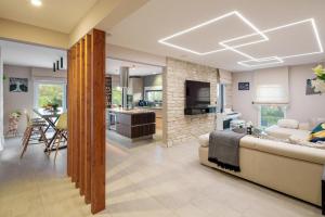 a living room with a couch and a dining room at Villa E&N in Brodarica