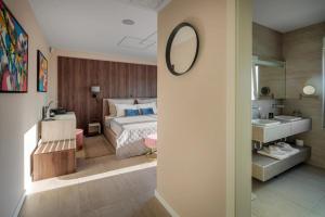 a bedroom with a bed and a sink and a mirror at Villa E&N in Brodarica +29 photos