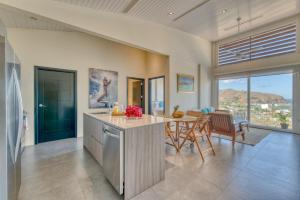 an open kitchen and dining room with a table at La Santa Maria Resort in San Juan del Sur