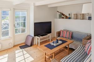 a living room with a couch and a table at Feriehus - Arendal ved sjøen in Arendal