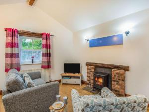 a living room with two couches and a fireplace at 1 Bed in Keswick 86245 in Rosthwaite +4 photos