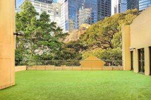 un ampio cortile con erba verde in una città di Sydney Harbour Marriott Hotel at Circular Quay a Sydney