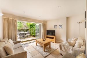 a living room with two couches and a television at Ralston in Ambleside