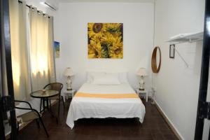 Hostal Mi Rincón في سانتو دومينغو: غرفة نوم بسرير ودهان على الحائط