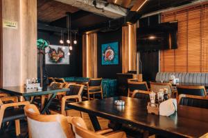 a restaurant with tables and chairs in a room at Hotel Aleksandrija in Ohrid