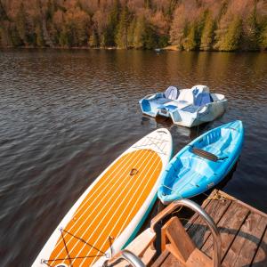 eine Gruppe von drei Booten, die auf einem See sitzen in der Unterkunft Cabines Niksen in Saint Adolphe D'Howard