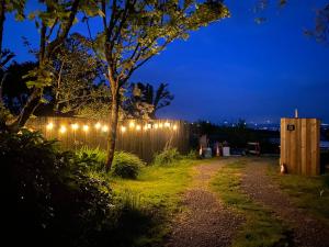 a fence with lights on it at night at Stunning views & sunrises from Sally Saracen in St Ives +26 photos