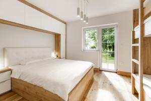 a bedroom with a large bed and a window at Apartment Tina - Lipa 33 in Podčetrtek