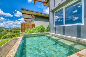 a swimming pool in the backyard of a house at La Santa Maria Resort in San Juan del Sur