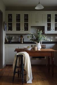 a kitchen with a wooden table in a kitchen at Elm Tree Cottage in Fivemiletown
