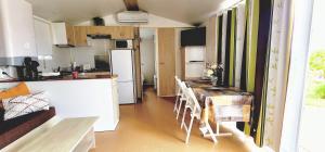 a kitchen with a table and chairs in a room at Casa Floravista in Bombarral