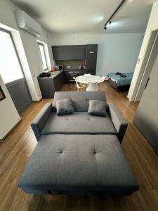 a living room with a couch and a table at Modern Studio in Central Victoria in Victoria