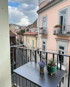 a balcony with a table with flowers on it at Le Muse Loft in Caserta