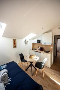 a bedroom with a bed and a table and chairs at BLD-Location in Le Gond-Pontouvre