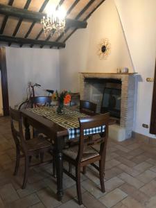 a dining room with a table and a fireplace at La Casa di Helena in Stroncone +14 photos