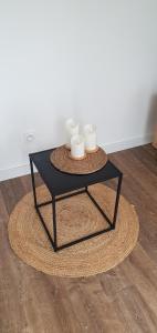 a black coffee table with three mugs on it at Charmant logement neuf in Hourtin